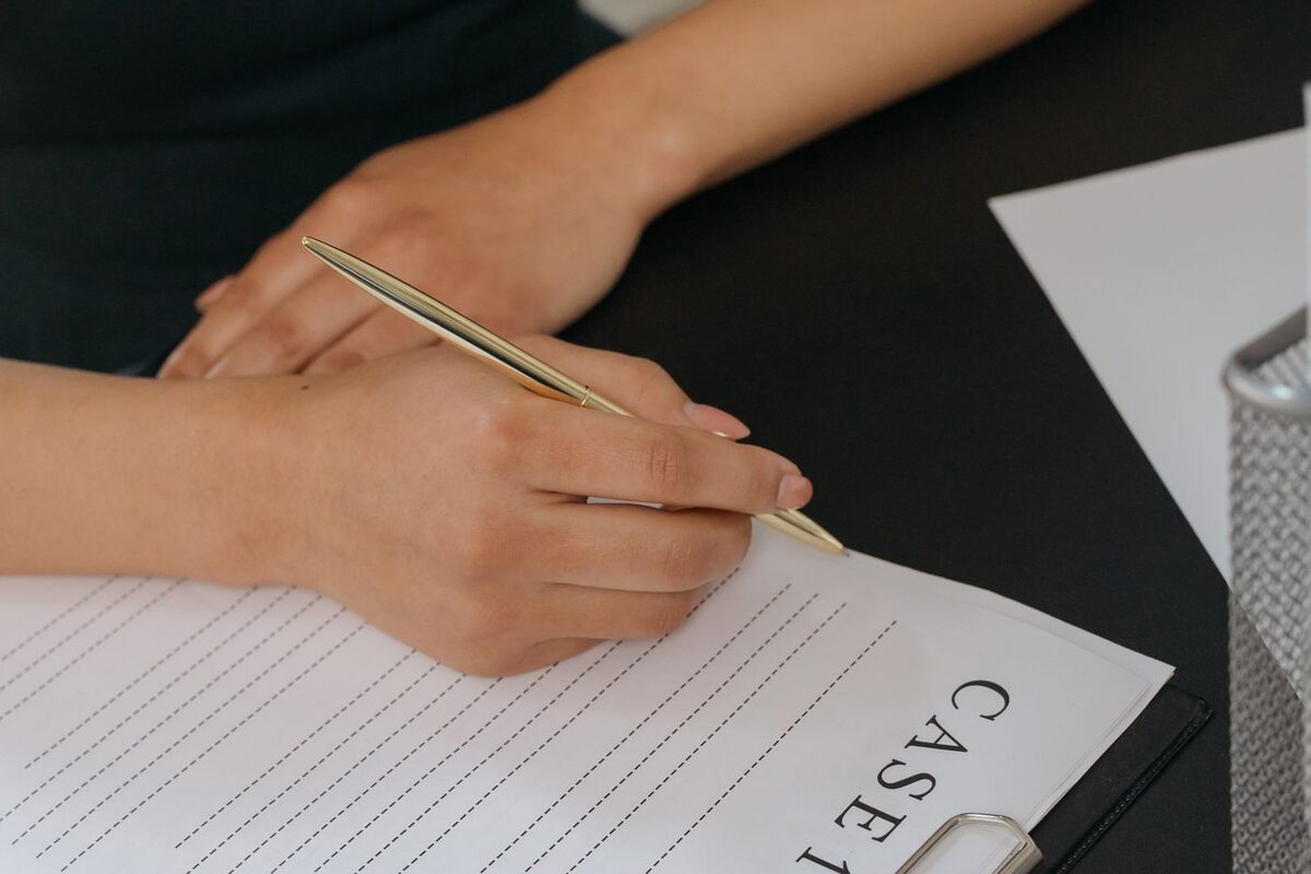 Hand signing a divorce case file - divorce document preparation and filing
