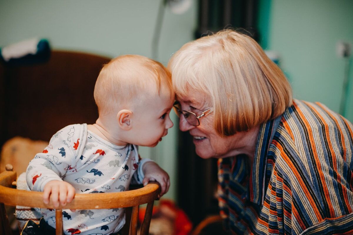 Grandmother leaning in close to a smiling toddler - guardianship of a minor in California