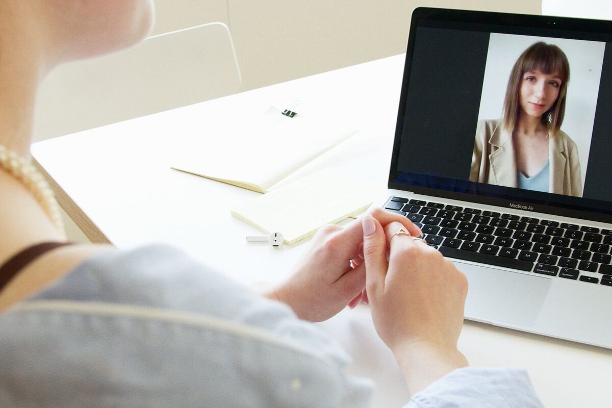 Video call on a laptop while reviewing documents at a desk - online paralegal assistance
