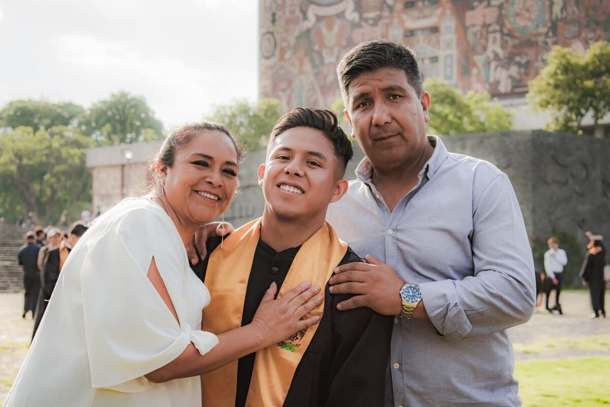 Parents hugging their son at his high school graduation - the year many special-needs families start the limited conservatorship process