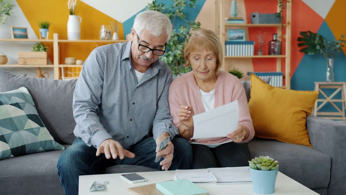 Older couple sitting together reviewing paperwork and costs - what a California conservatorship costs